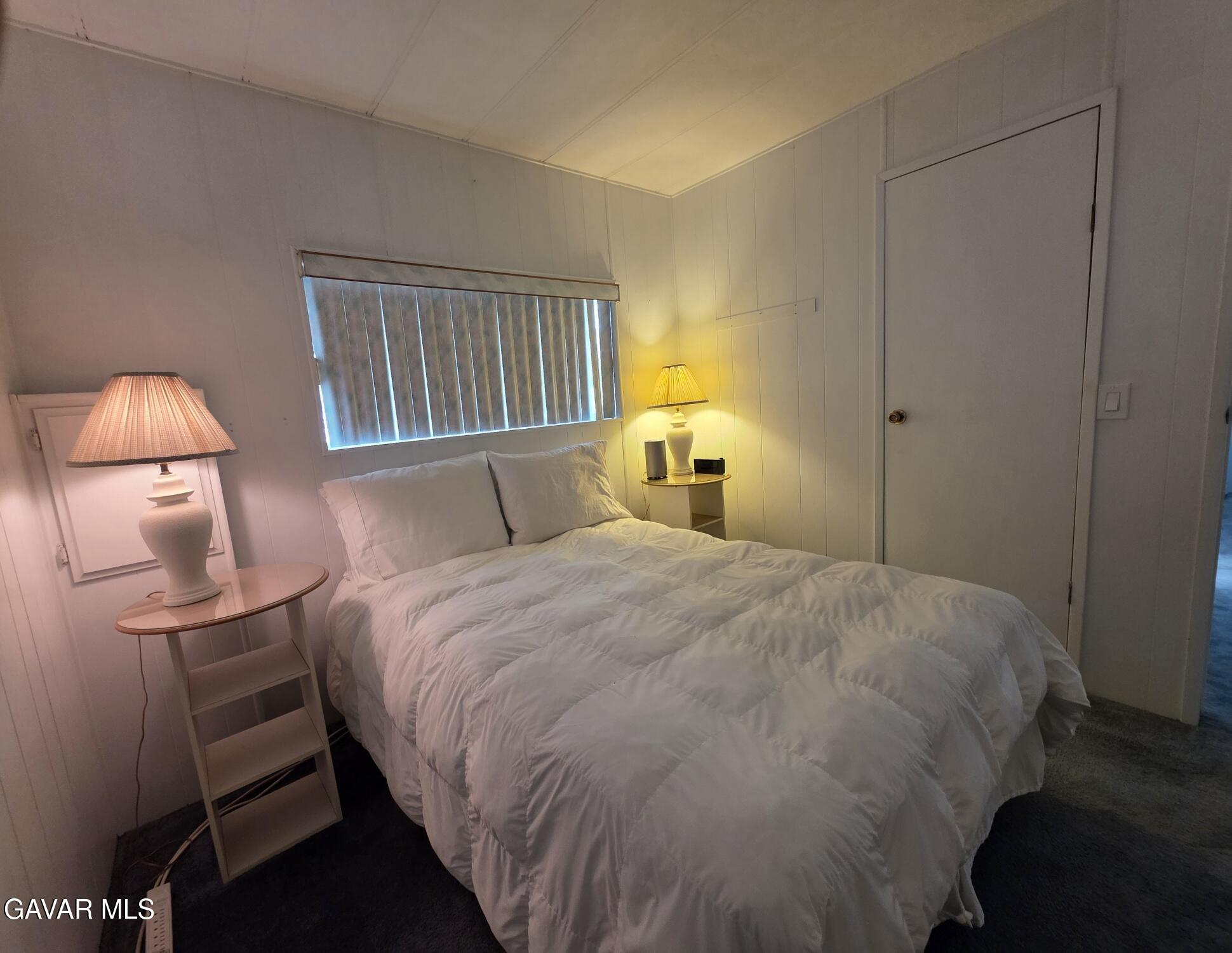 20806 Gridley Road Lakewood, CA 90715 - Photo 32 of 44 a bedroom with a bed and a lamp