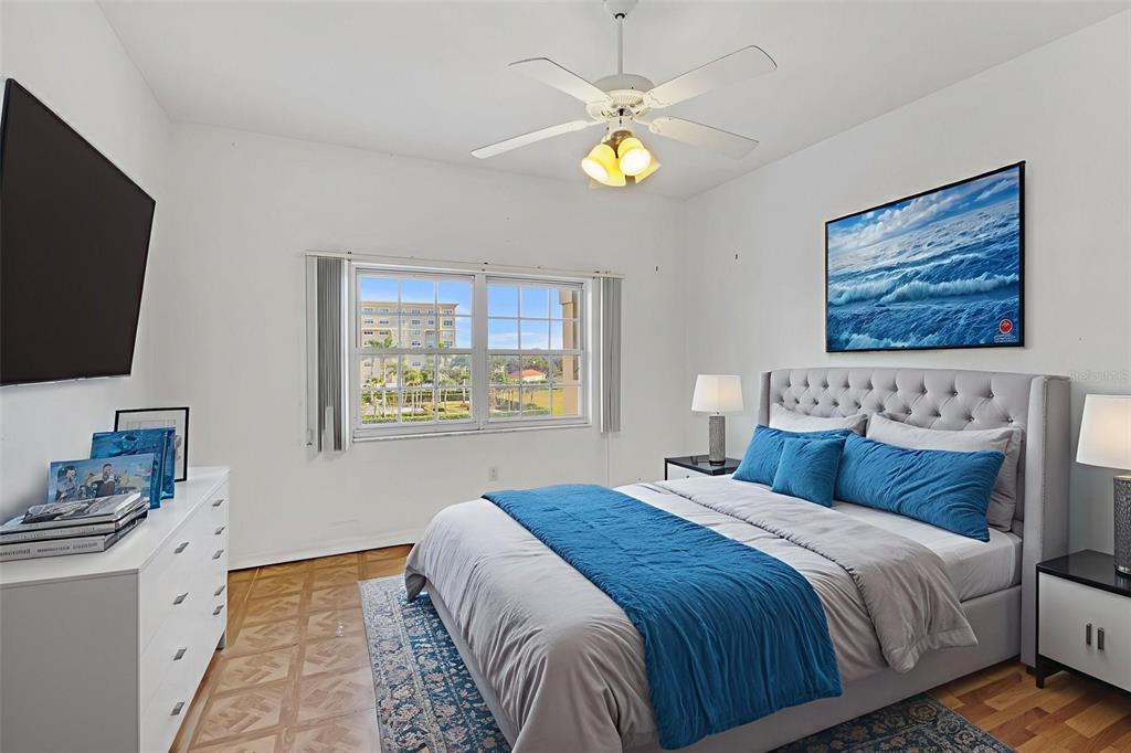 3730 Cadbury Circle, Unit 431 Venice, FL 34293 - Photo 19 of 34 a bedroom with a bed and a flat screen tv