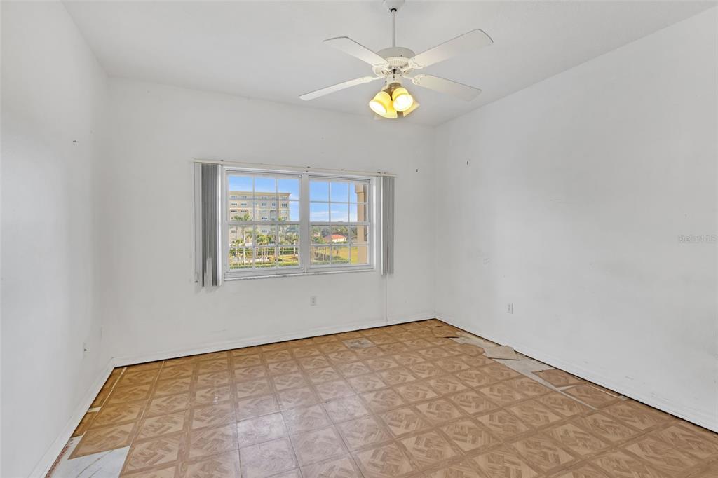 3730 Cadbury Circle, Unit 431 Venice, FL 34293 - Photo 20 of 34 an empty room with a chandelier fan