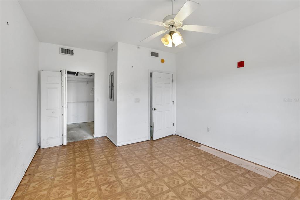 3730 Cadbury Circle, Unit 431 Venice, FL 34293 - Photo 21 of 34 an empty room with a mirror and fan