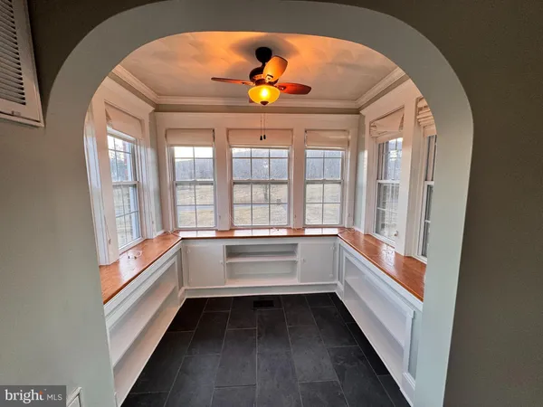 a storage room with wooden floor and windows