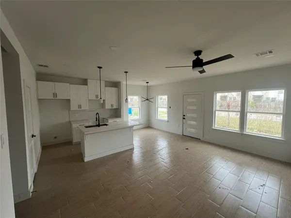 a large kitchen with stainless steel appliances a large counter top