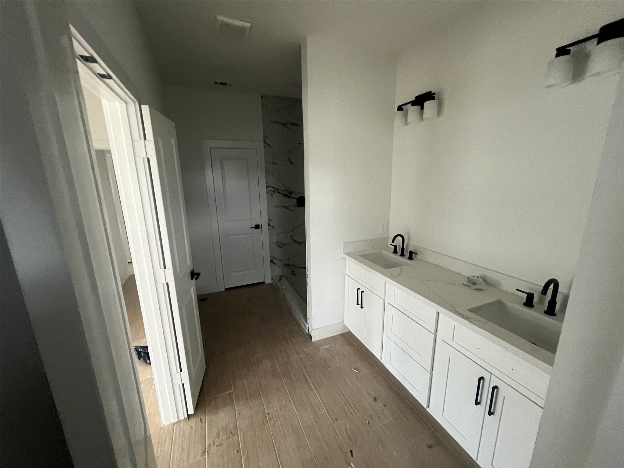 5710 Delmack Street, Unit B Houston, TX 77032 - Photo 8 of 12 a spacious bathroom with a double vanity sink and a mirror