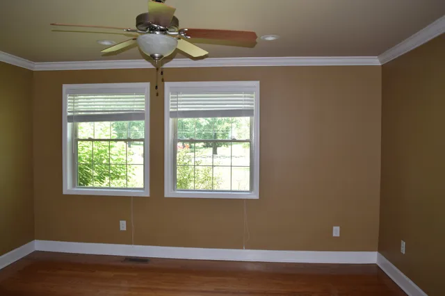 a view of room with window and wooden floor