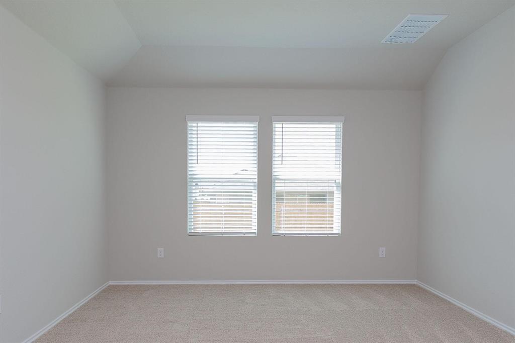 6009 Ronee Leah Drive Austin, TX 78724 - Photo 9 of 16 A quiet space with soft carpeting and sun-drenched windows, perfect for serene living.