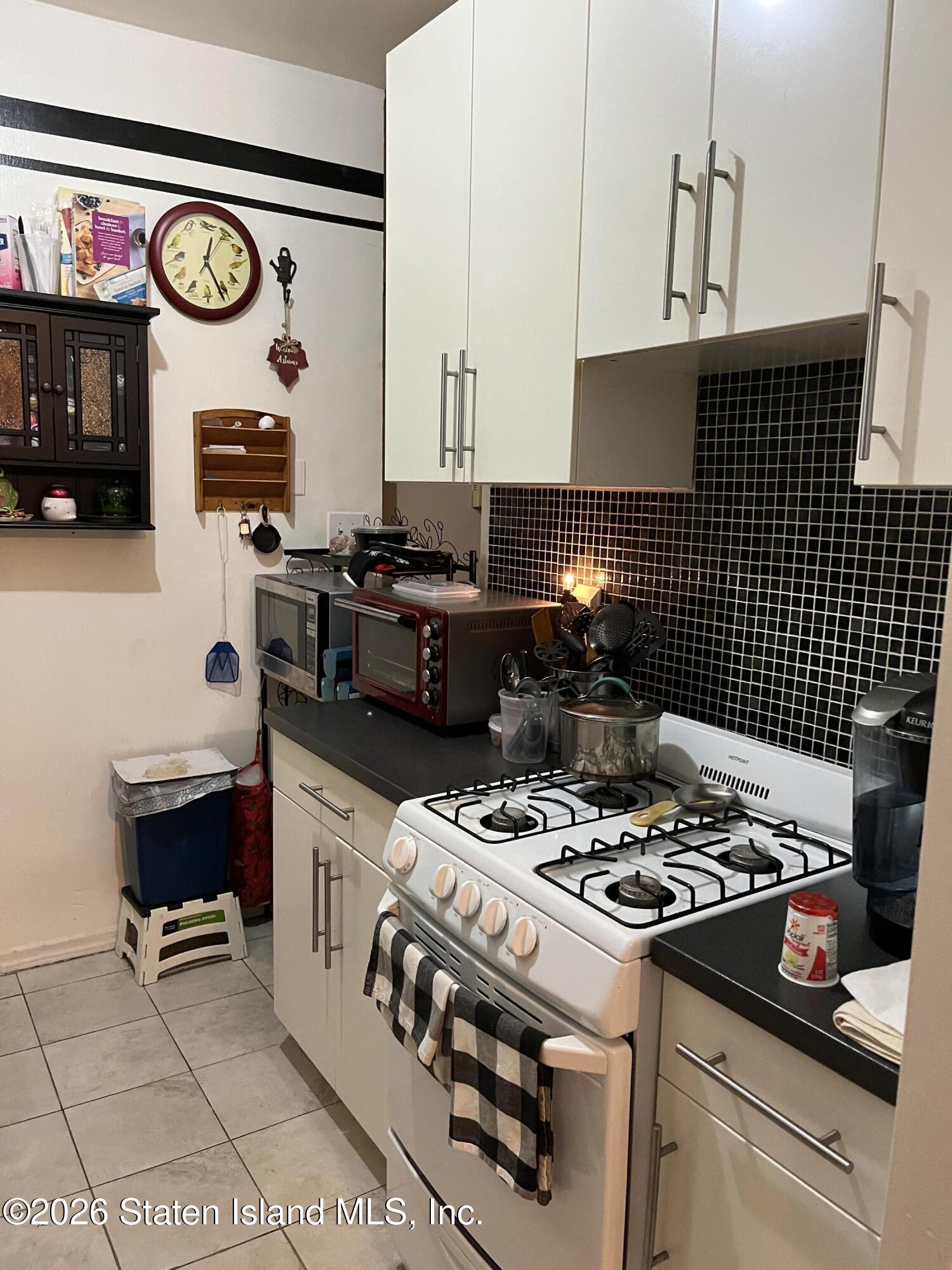1000 Clove Road, Unit LD Staten Island, NY 10301 - Photo 12 of 21 a kitchen with a stove and a table