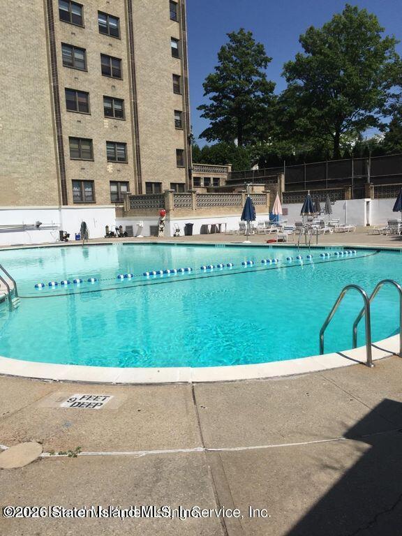 1000 Clove Road, Unit LD Staten Island, NY 10301 - Photo 20 of 21 a view of swimming pool with outdoor seating and yard
