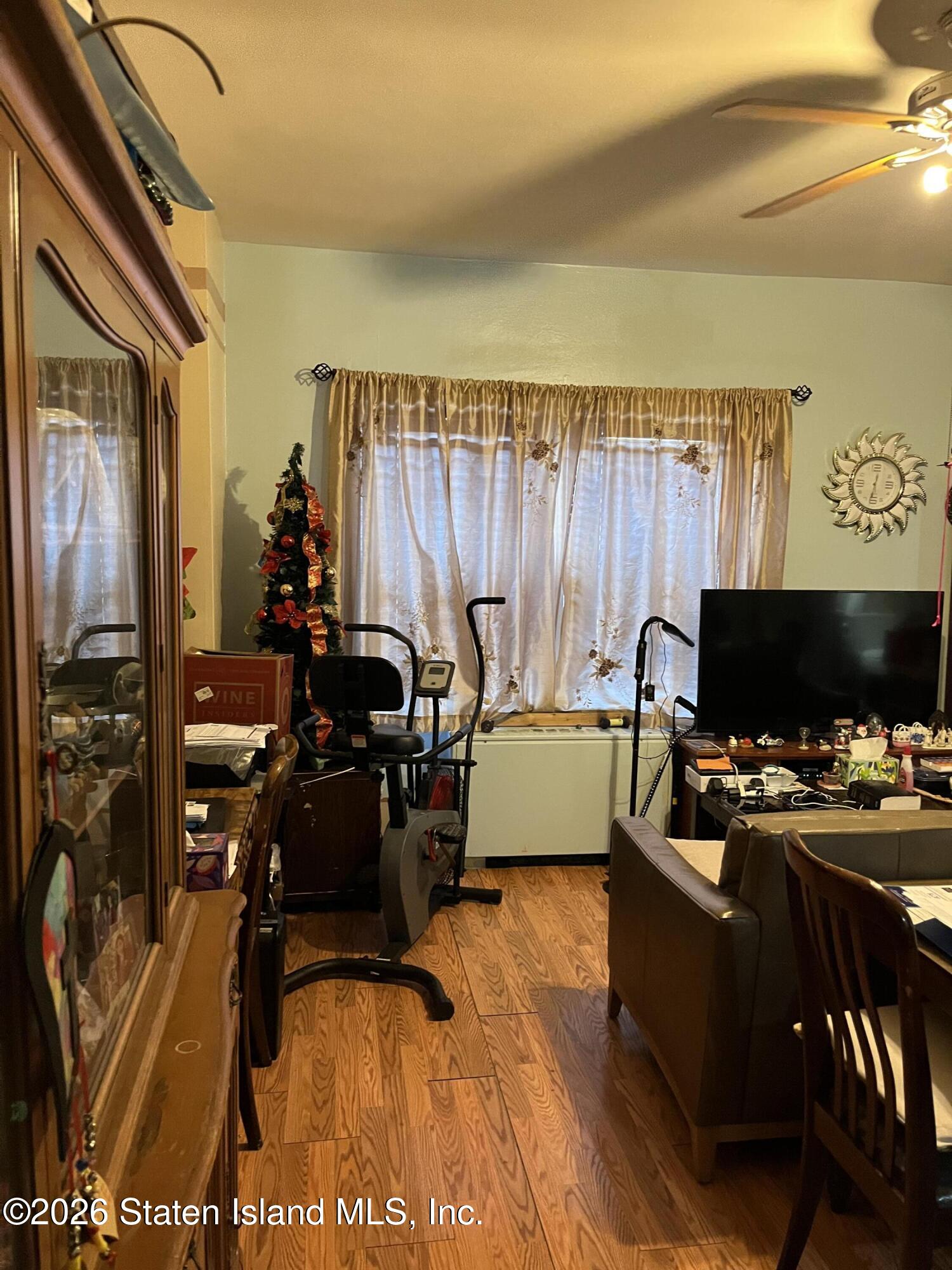 1000 Clove Road, Unit LD Staten Island, NY 10301 - Photo 10 of 21 a view of a workspace with furniture and a flat screen tv