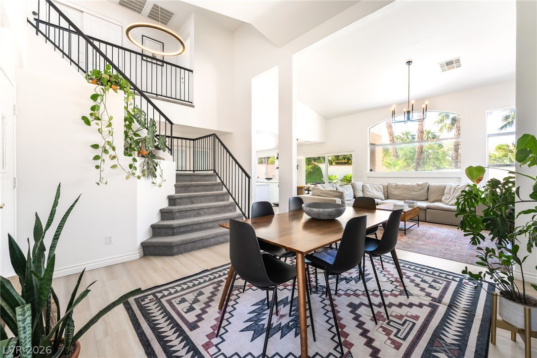 1941 Ivy Point Lane Las Vegas, NV 89134 - Photo 4 of 21 This airy interior space features a grand staircase and abundant natural light illuminating the dining and living areas.