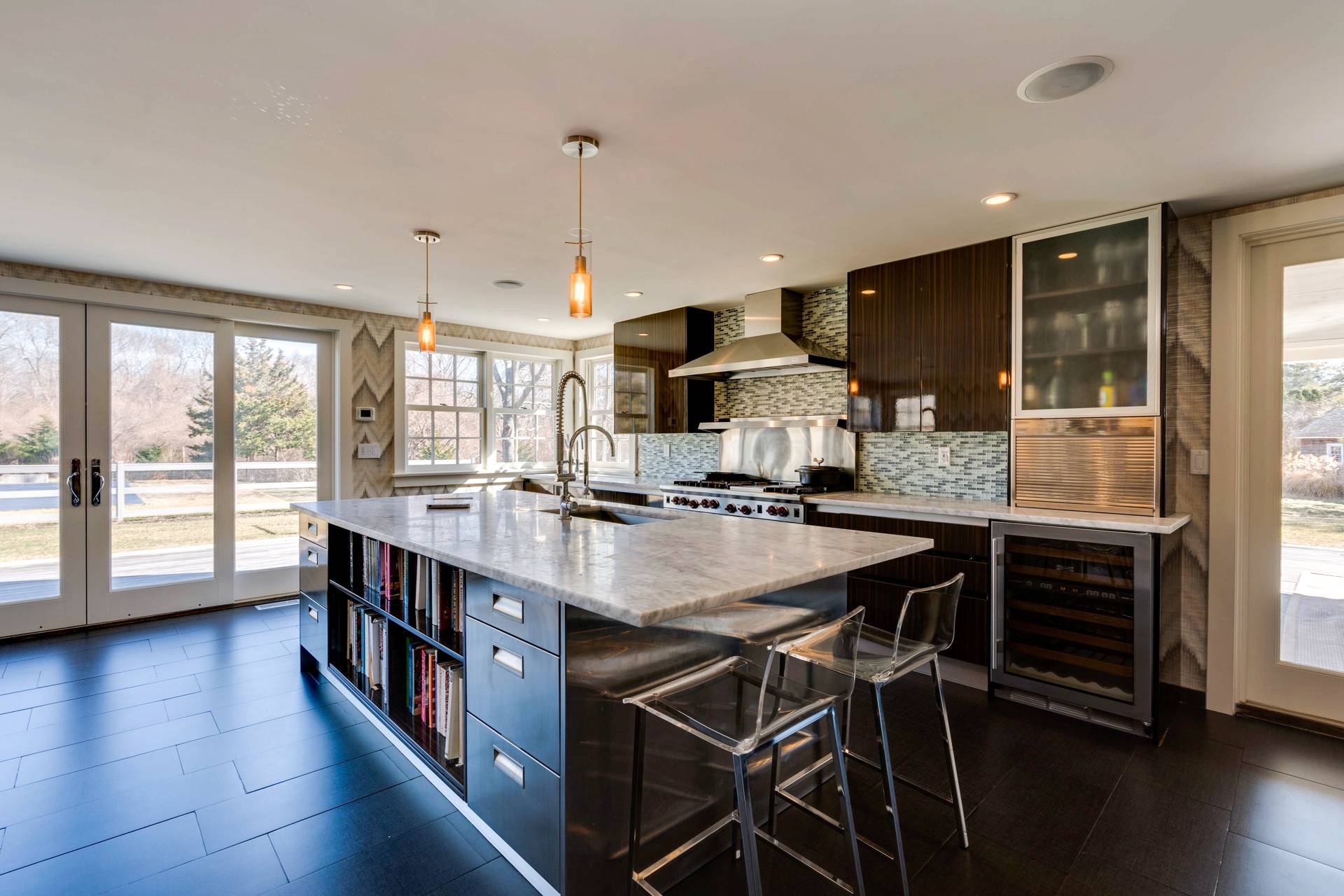 274 Ferry Road Sag Harbor, NY 11963 - Photo 22 of 50 a kitchen with stainless steel appliances granite countertop a stove a sink dishwasher and a dining table with wooden floor