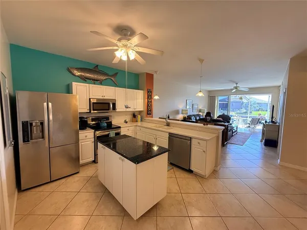 a kitchen with a refrigerator and a sink