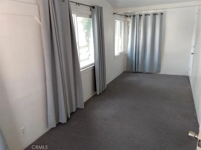 a view of a big room with windows and closet