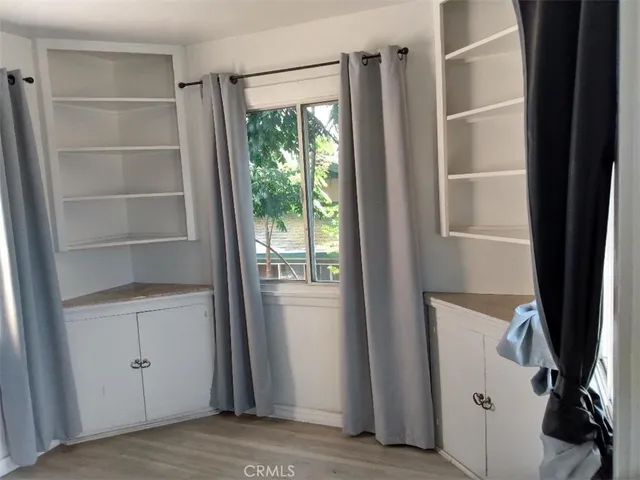 a view of a room with an empty space and a window