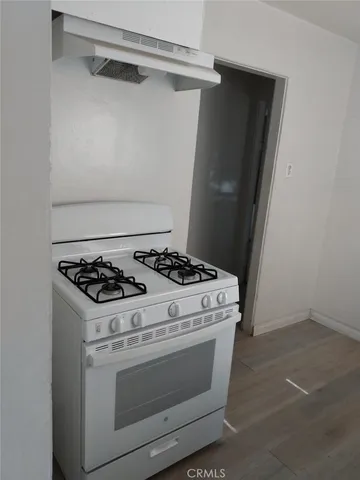 a stove top oven sitting inside of a kitchen