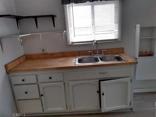 a kitchen with a sink and wooden cabinets