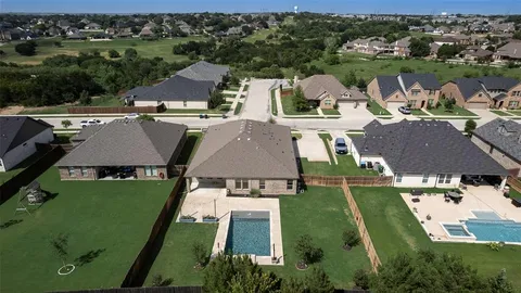 an aerial view of residential houses with outdoor space and river