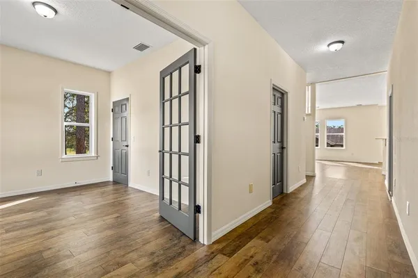 a view of a livingroom with wooden floor and a window