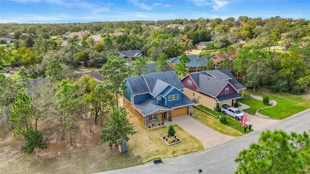 an aerial view of a house with a yard and lake view