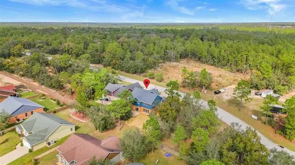 an aerial view of residential houses with outdoor space