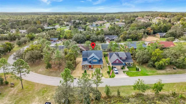 an aerial view of residential house with outdoor space and swimming pool