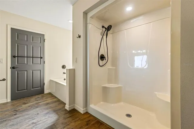 a bathroom with a glass shower door