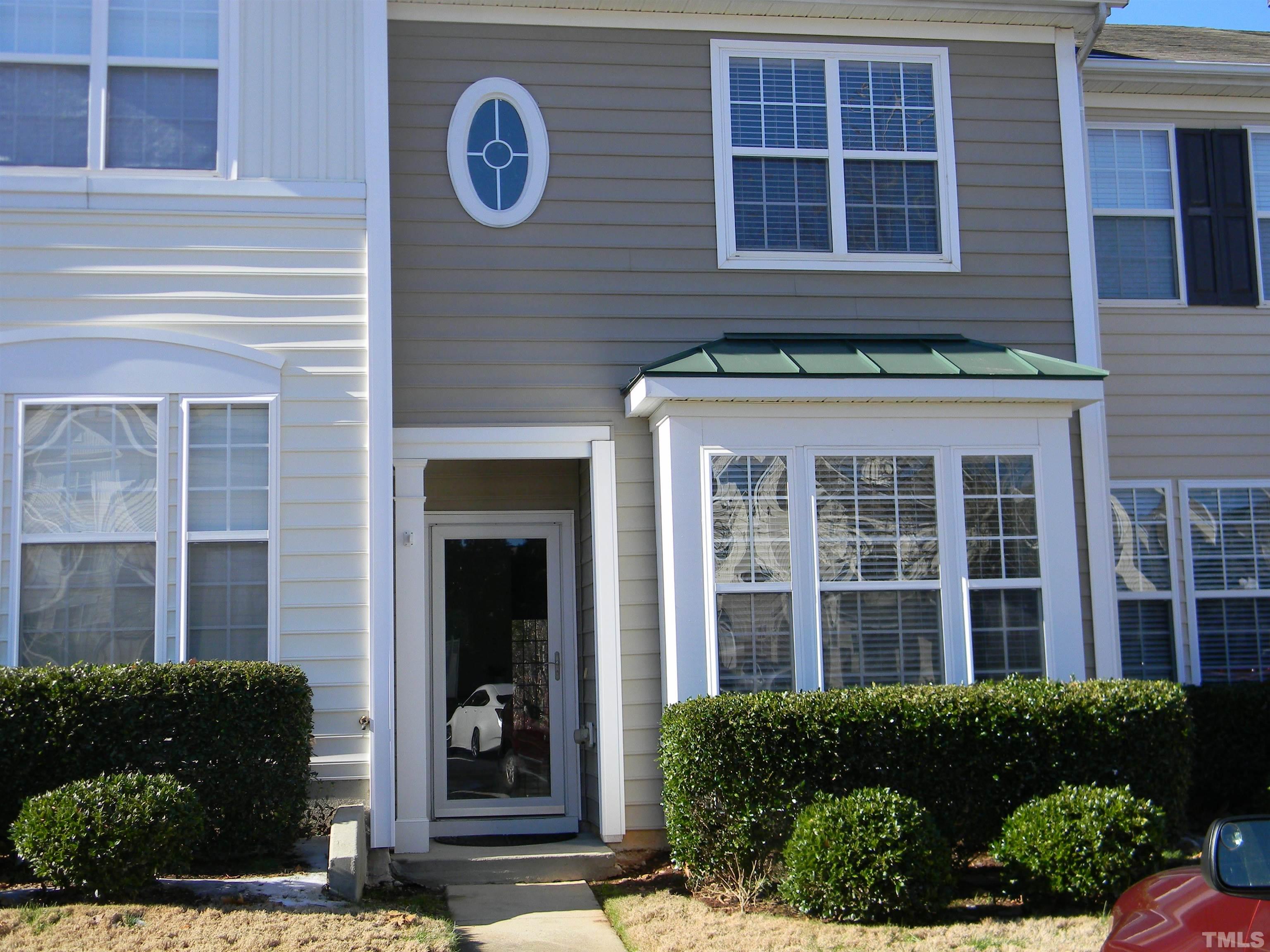 a view of a brick house with a large windows and a potted plant