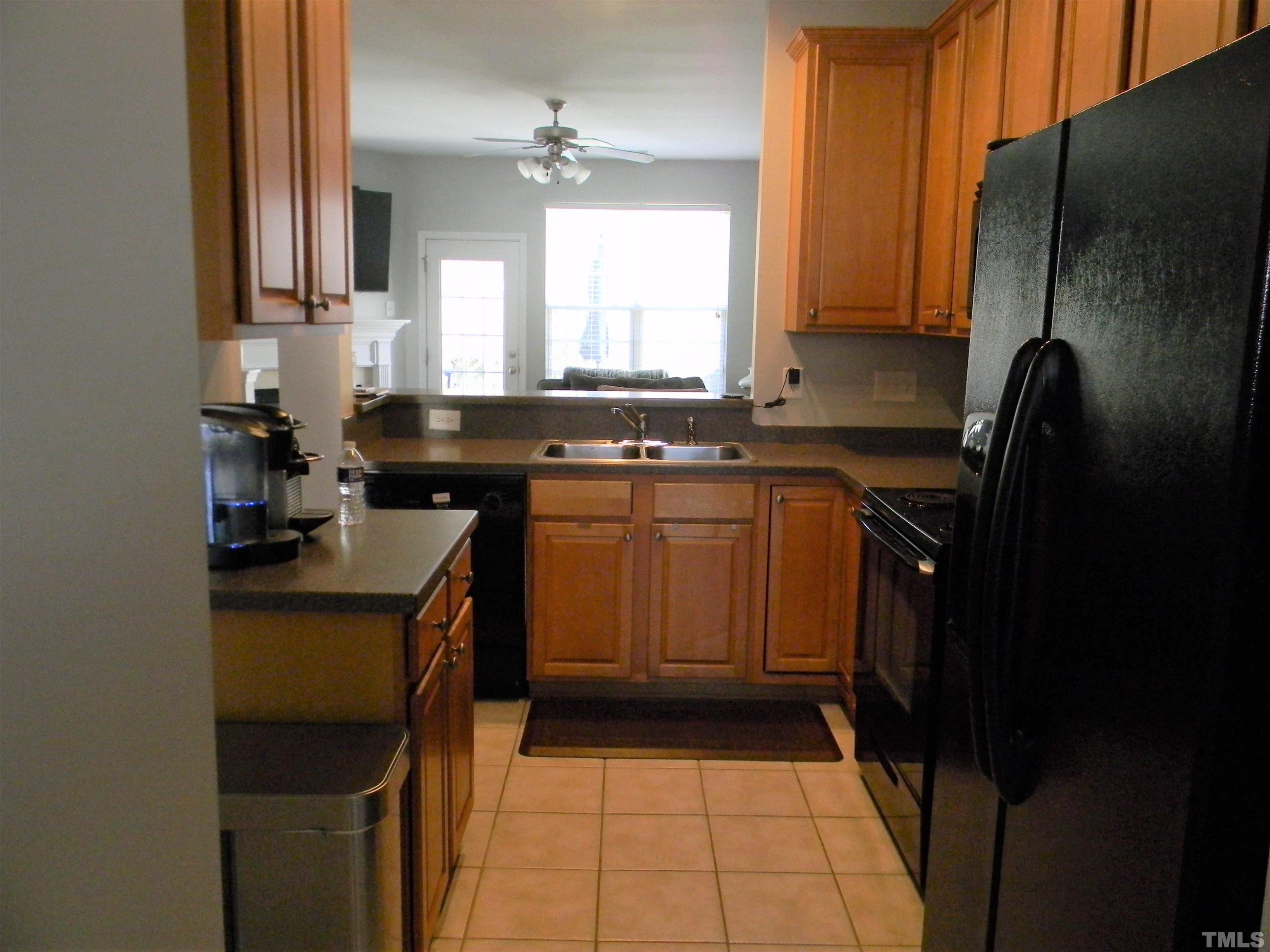 7717 Winners Edge Street Raleigh, NC 27617 - Photo 4 of 15 a kitchen with a sink a stove cabinets and a refrigerator