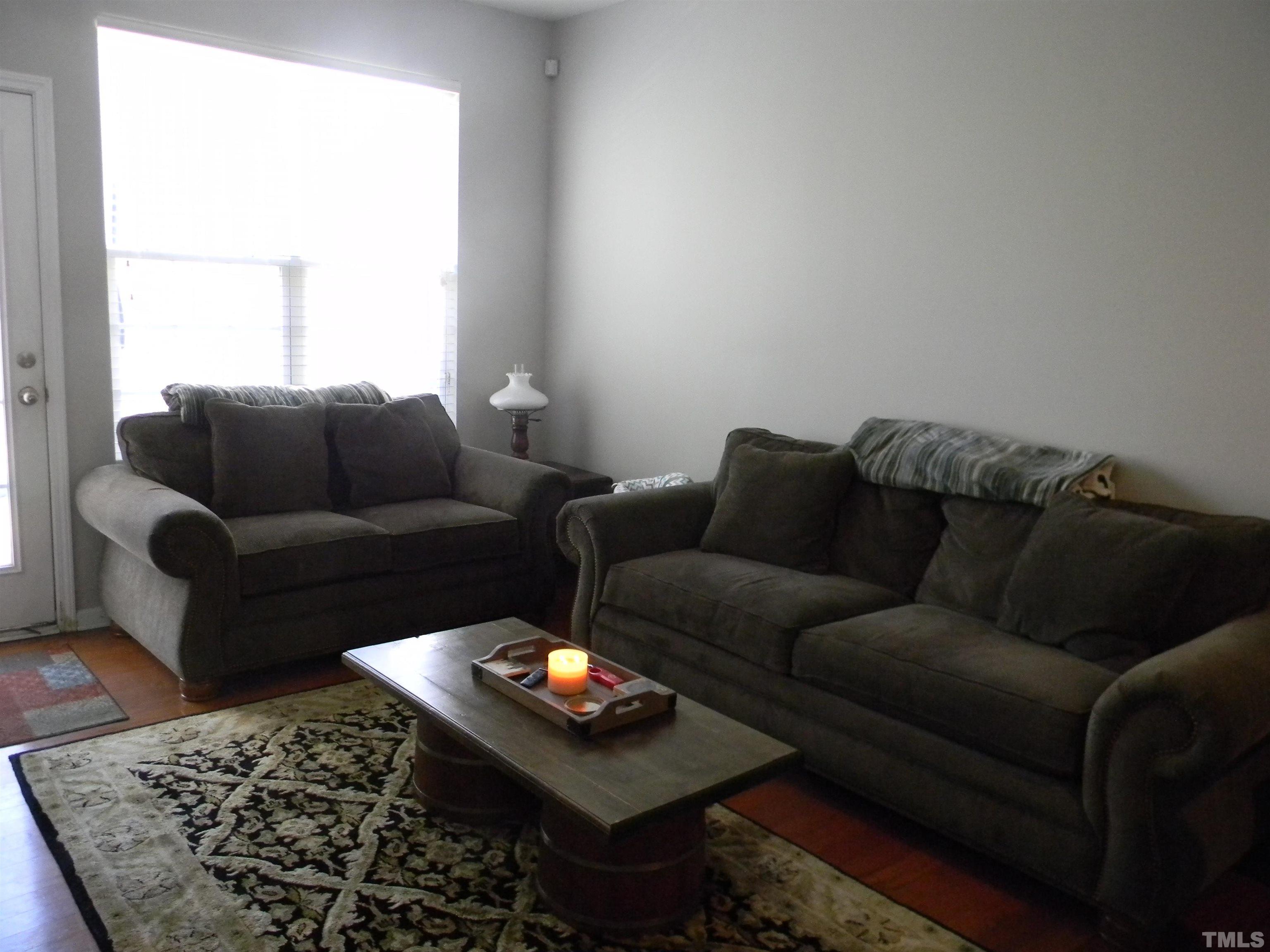 7717 Winners Edge Street Raleigh, NC 27617 - Photo 7 of 15 a living room with furniture and a couch