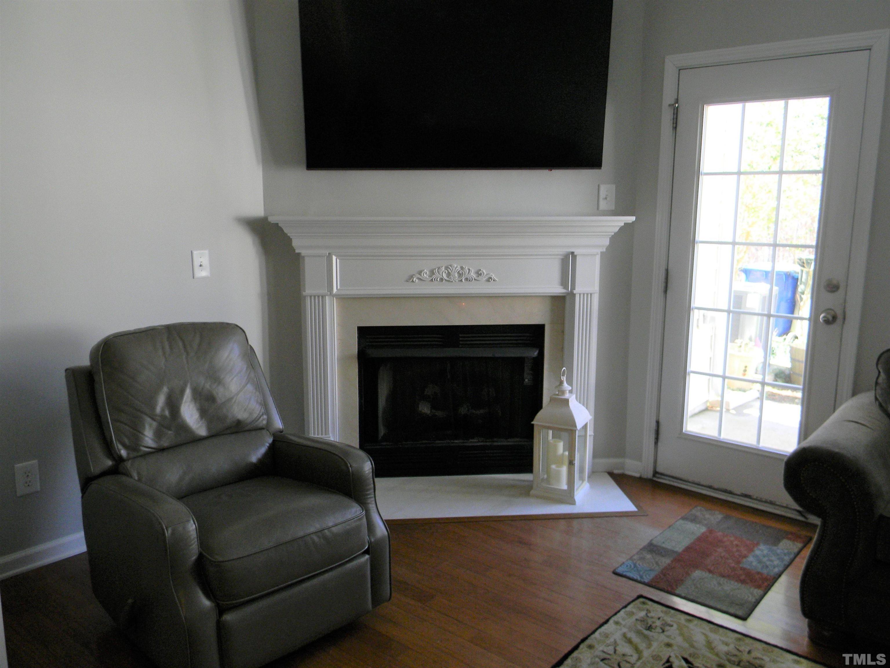 7717 Winners Edge Street Raleigh, NC 27617 - Photo 8 of 15 a living room with furniture and a fireplace