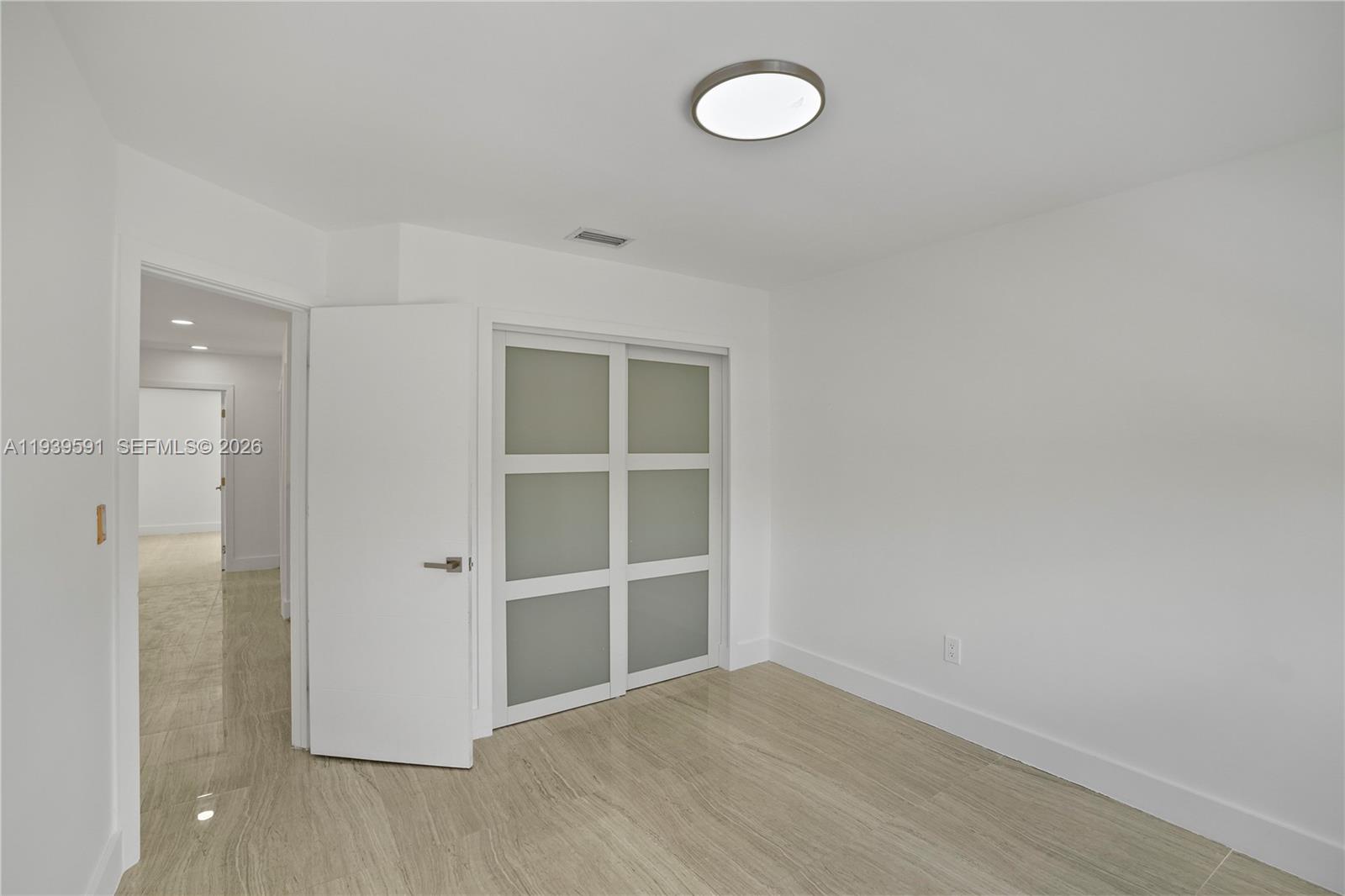 12894 Southwest 60th Terrace Miami, FL 33183 - Photo 25 of 66 a view of an empty room with wooden floor and a window