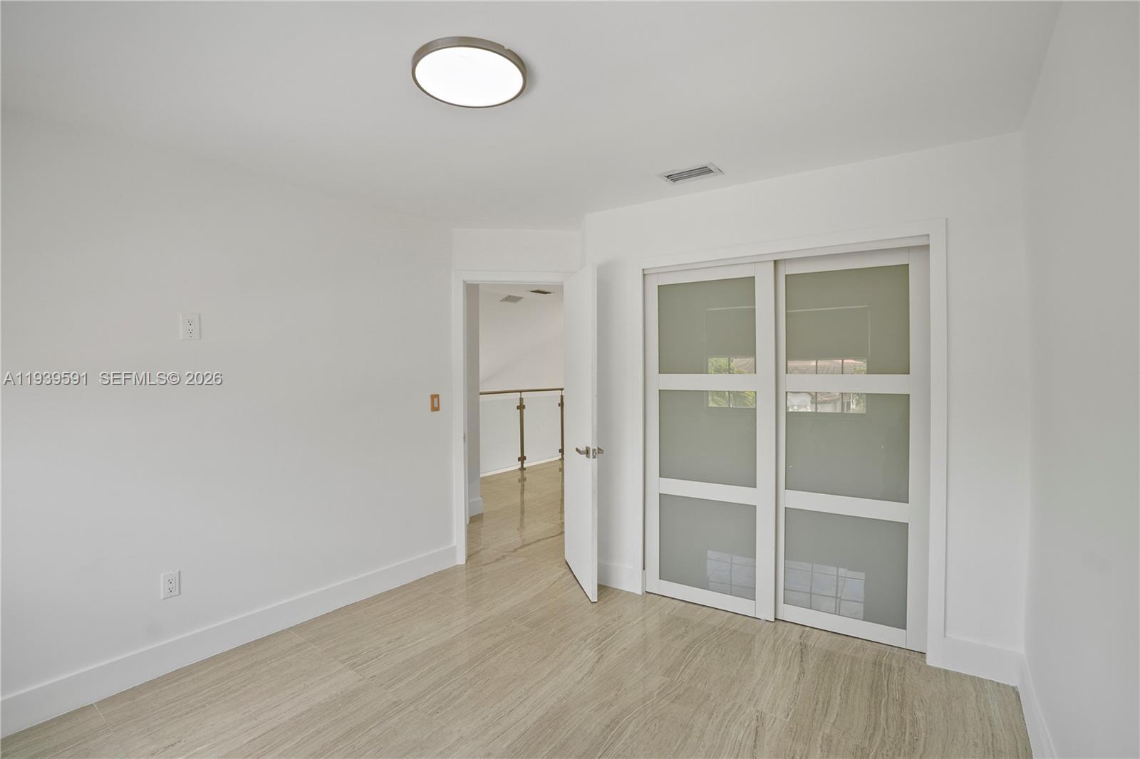 12894 Southwest 60th Terrace Miami, FL 33183 - Photo 26 of 66 a view of an empty room with wooden floor and a window