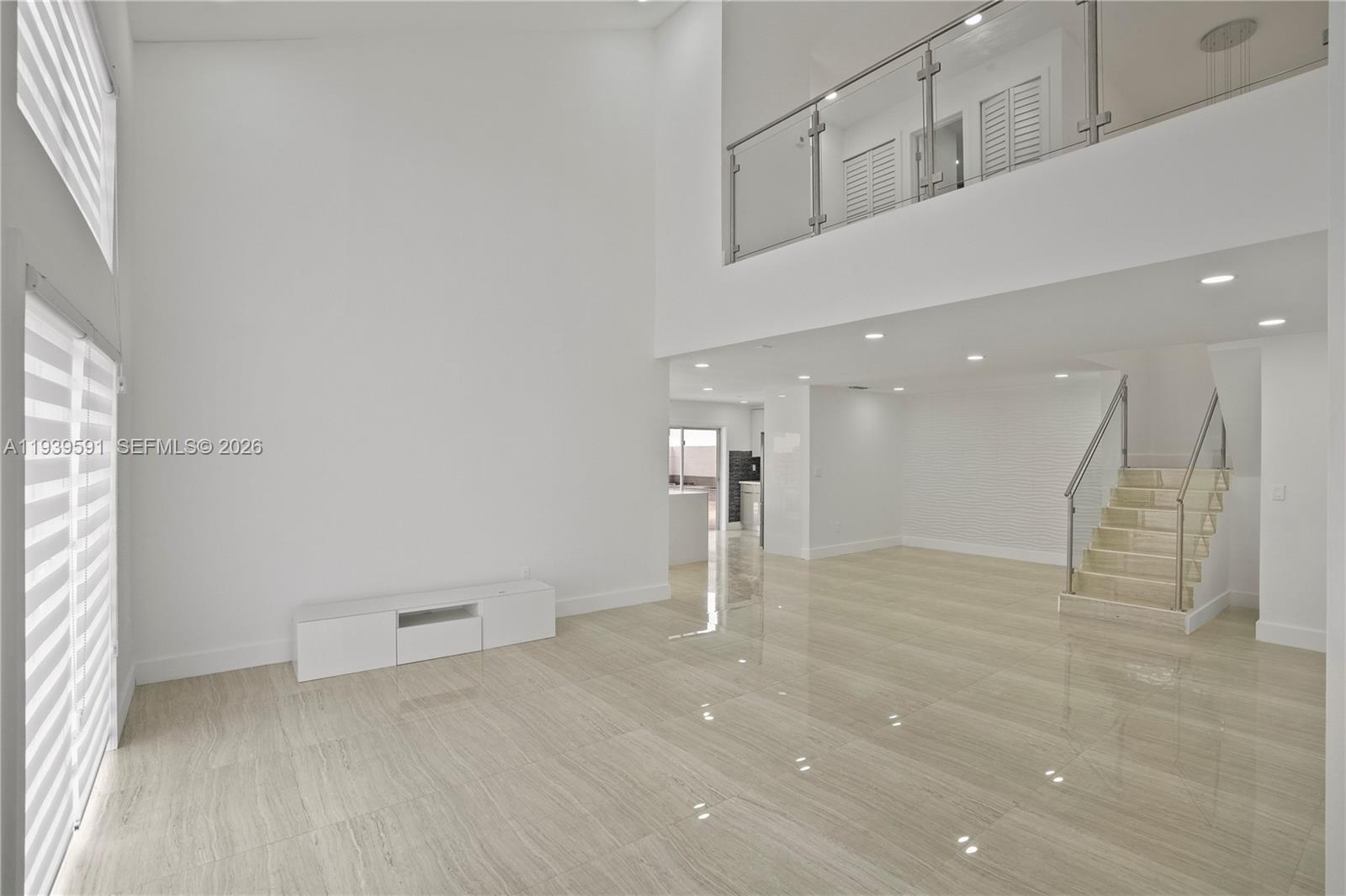 12894 Southwest 60th Terrace Miami, FL 33183 - Photo 3 of 66 an empty room with wooden floor and windows