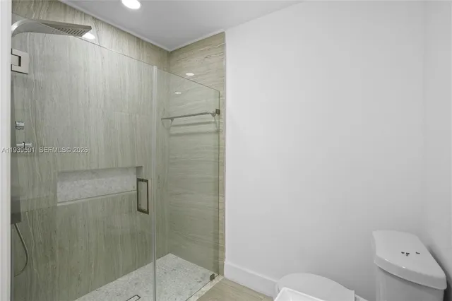 a bathroom with a shower and a sink