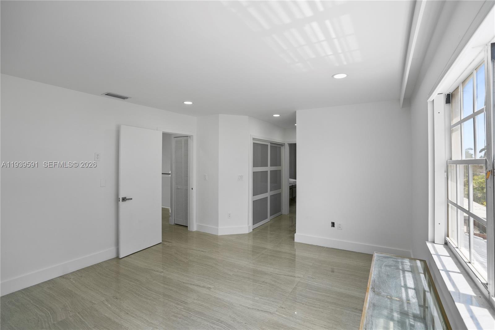 12894 Southwest 60th Terrace Miami, FL 33183 - Photo 38 of 66 wooden floor in an empty room with a window