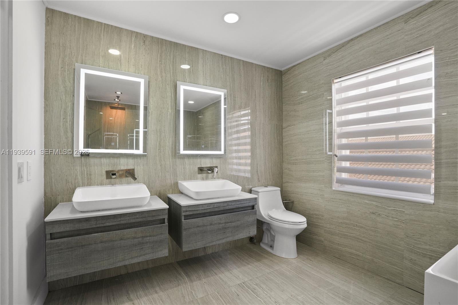 12894 Southwest 60th Terrace Miami, FL 33183 - Photo 40 of 66 a bathroom with a sink toilet and mirror