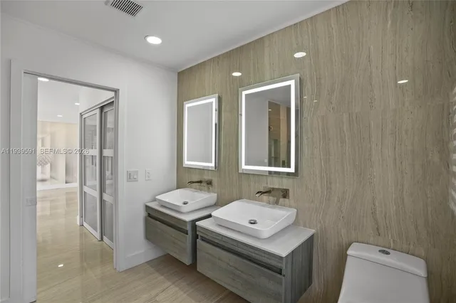 a palm tree sitting in front of a house with a yard