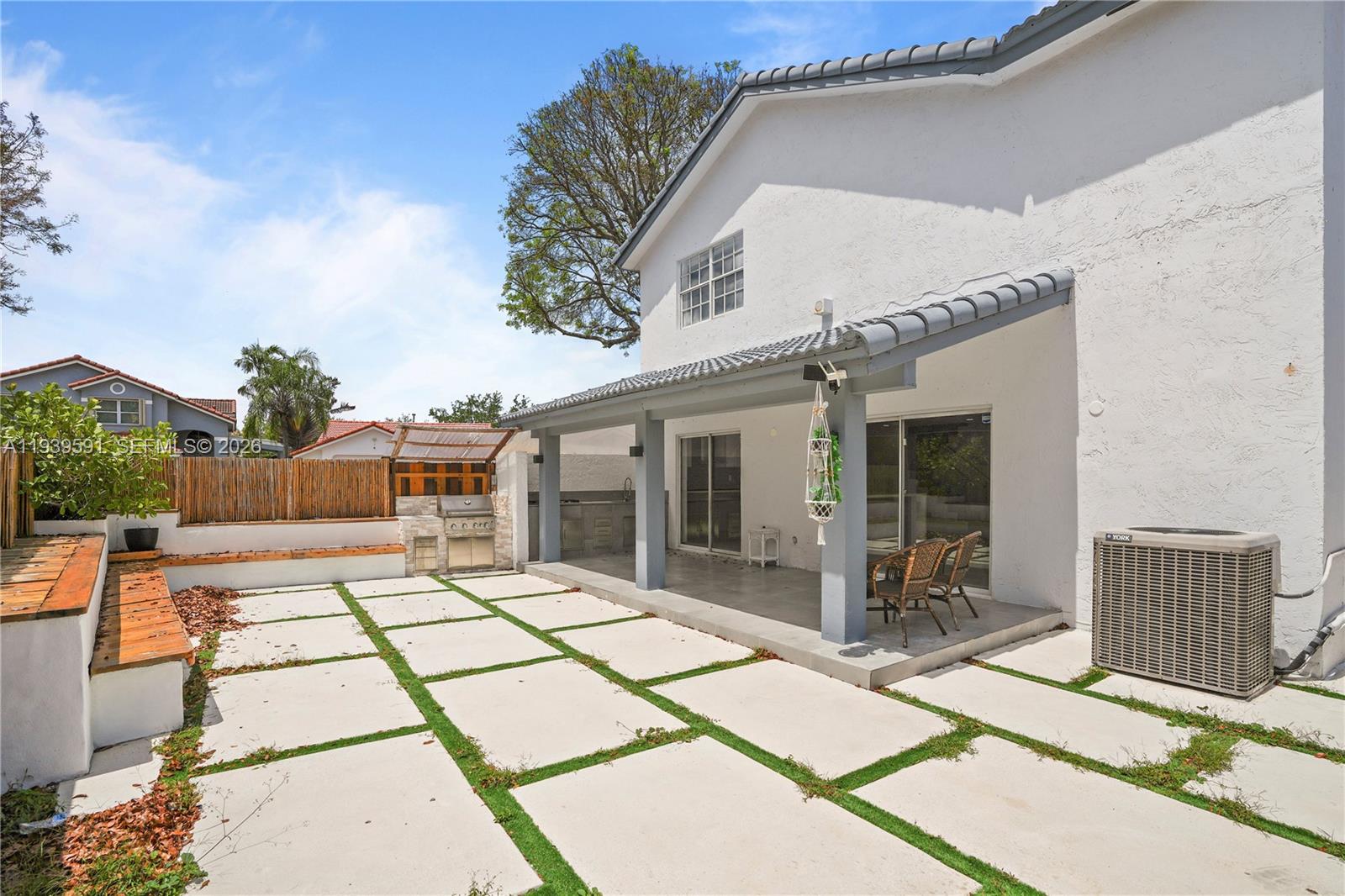 12894 Southwest 60th Terrace Miami, FL 33183 - Photo 51 of 66 a view of a patio with table and chairs with wooden floor and fence