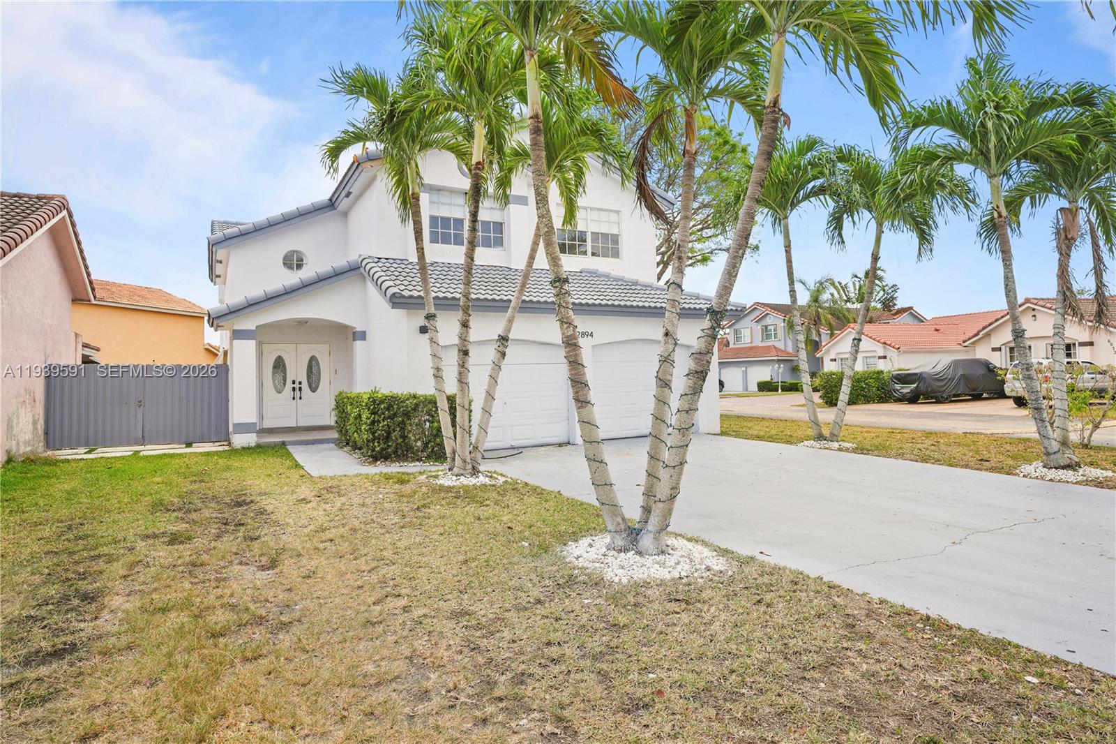 12894 Southwest 60th Terrace Miami, FL 33183 - Photo 58 of 66 a view of a house with a yard and palm trees