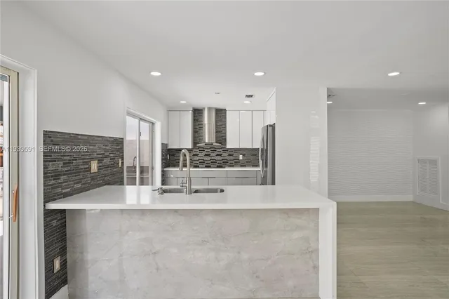 a kitchen with a sink and chandelier