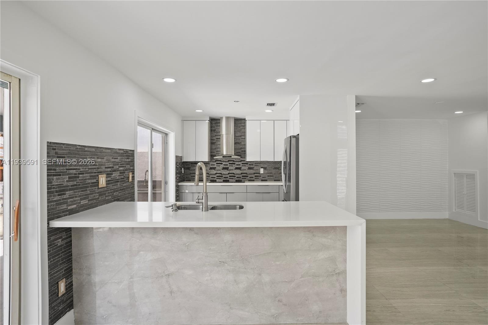 12894 Southwest 60th Terrace Miami, FL 33183 - Photo 10 of 66 a large kitchen with stainless steel appliances kitchen island granite countertop a refrigerator and cabinets