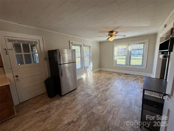 a view of kitchen with furniture and wooden floor