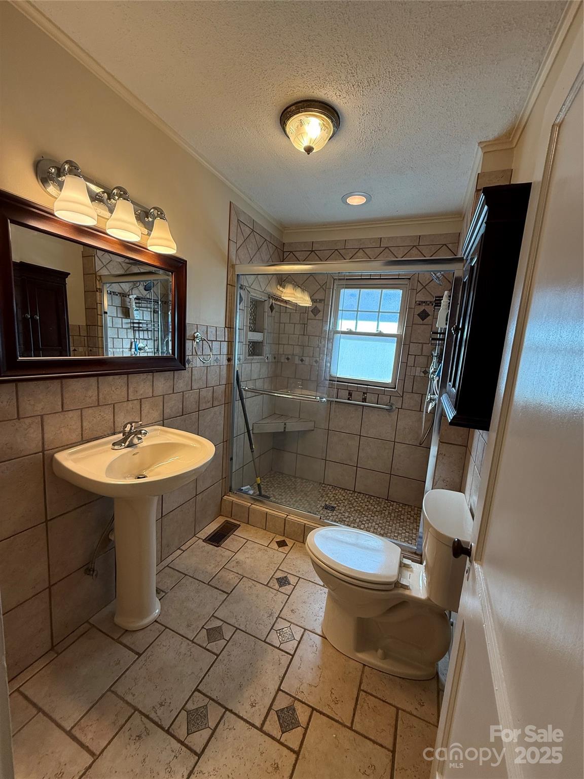 2550 Lail Road Glen Alpine, NC 28655 - Photo 18 of 35 a bathroom with a sink a toilet a mirror and shower