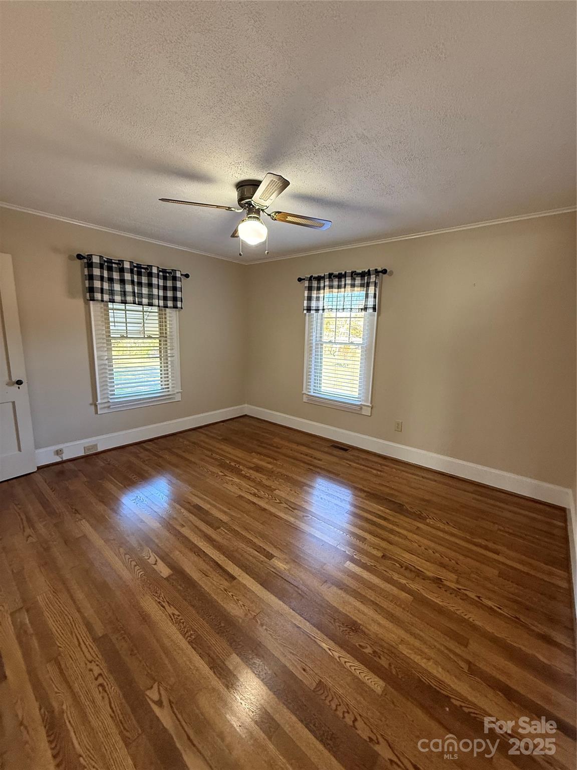 2550 Lail Road Glen Alpine, NC 28655 - Photo 20 of 35 an empty room with wooden floor and windows