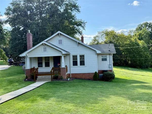 a view of a house with a yard porch and sitting area