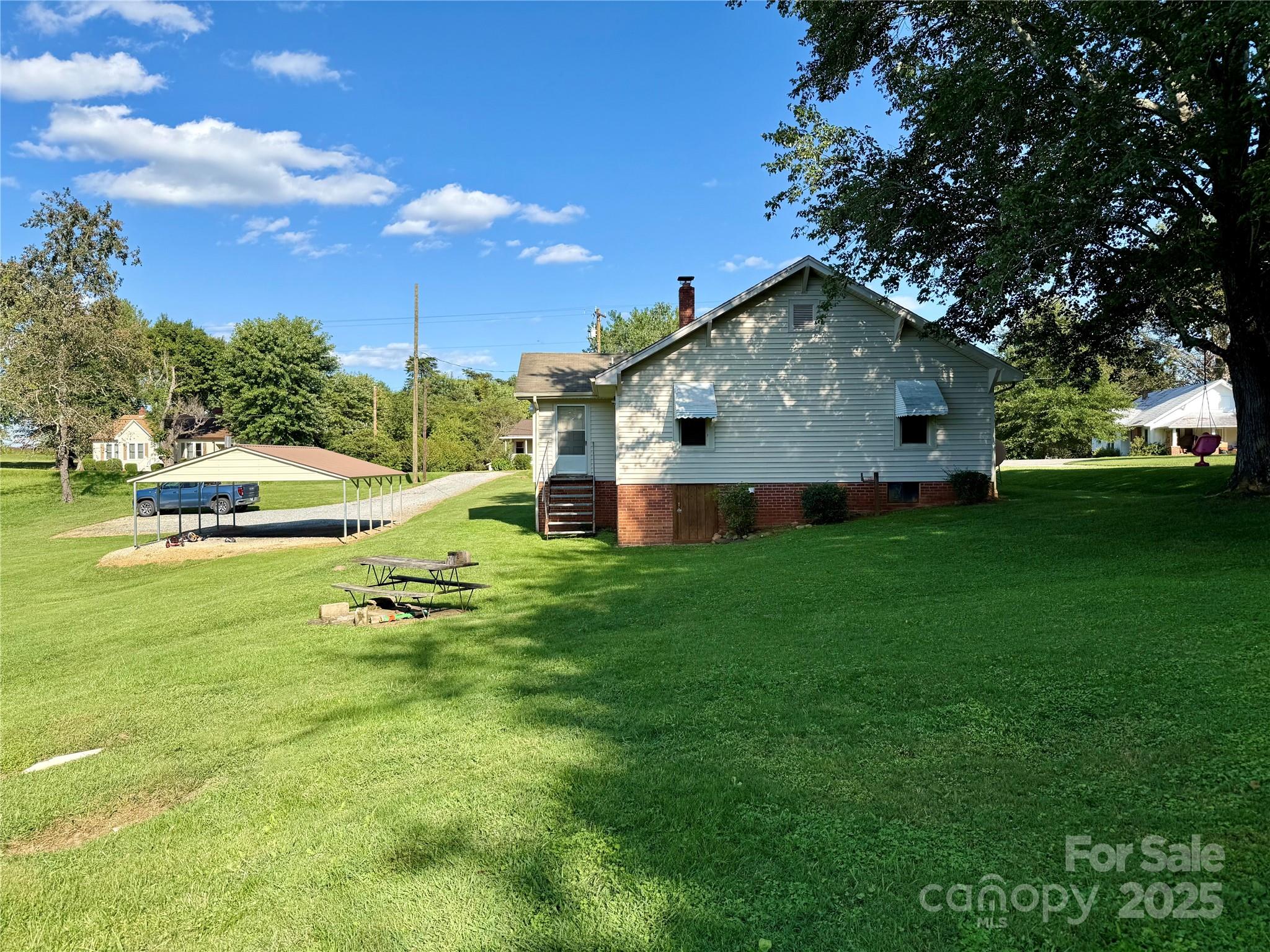 2550 Lail Road Glen Alpine, NC 28655 - Photo 4 of 35 a front view of a house with garden