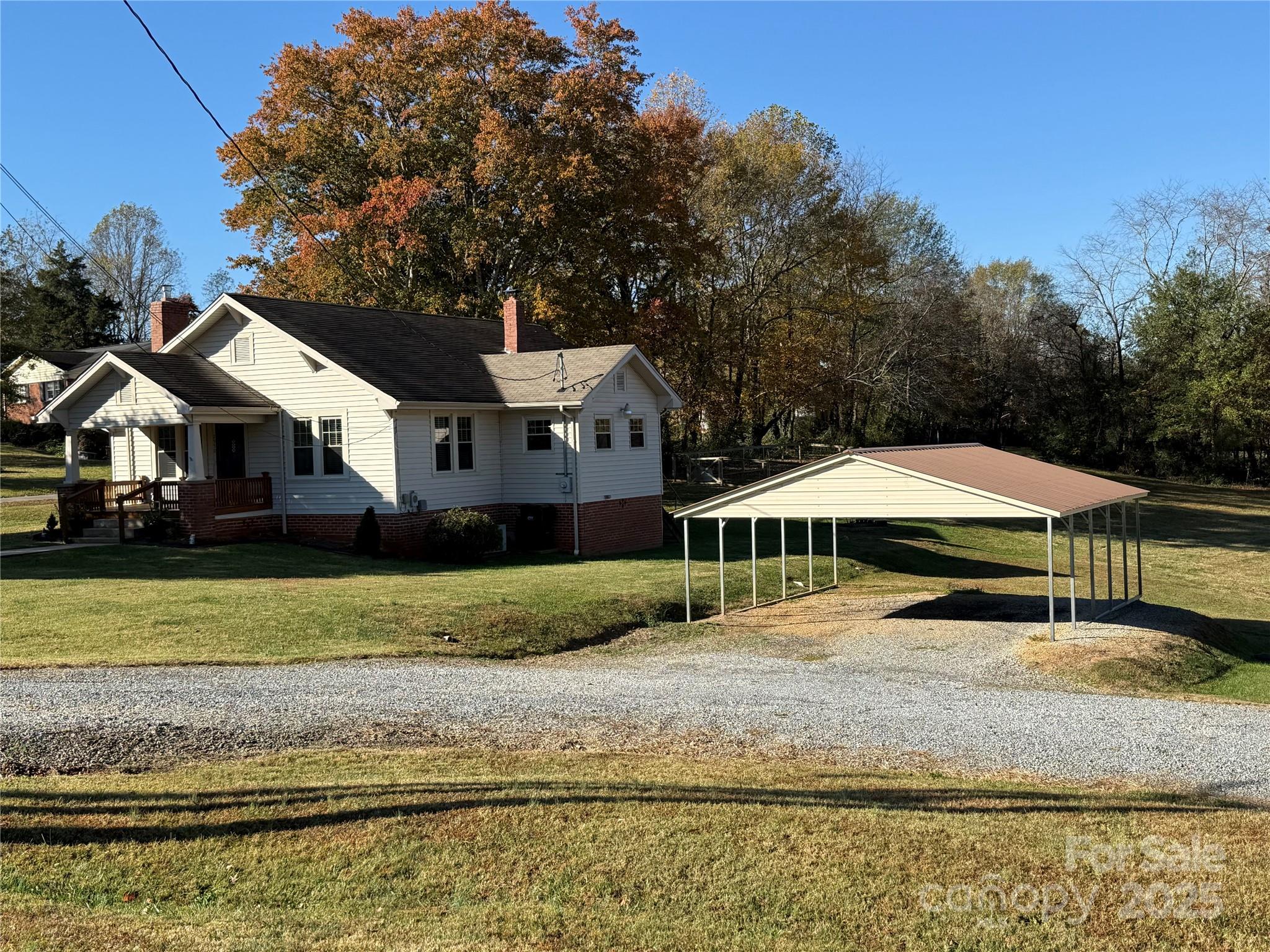 2550 Lail Road Glen Alpine, NC 28655 - Photo 5 of 35 a house with a garden and trees