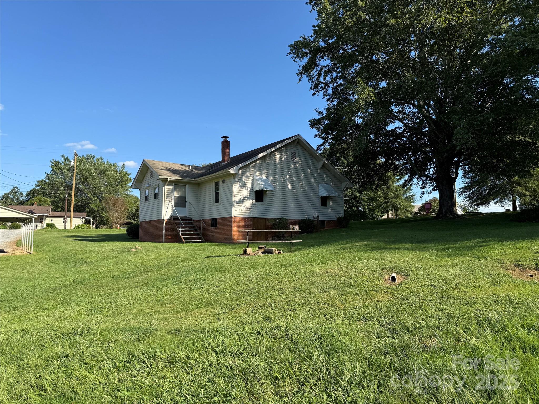 2550 Lail Road Glen Alpine, NC 28655 - Photo 6 of 35 a front view of a house with a garden