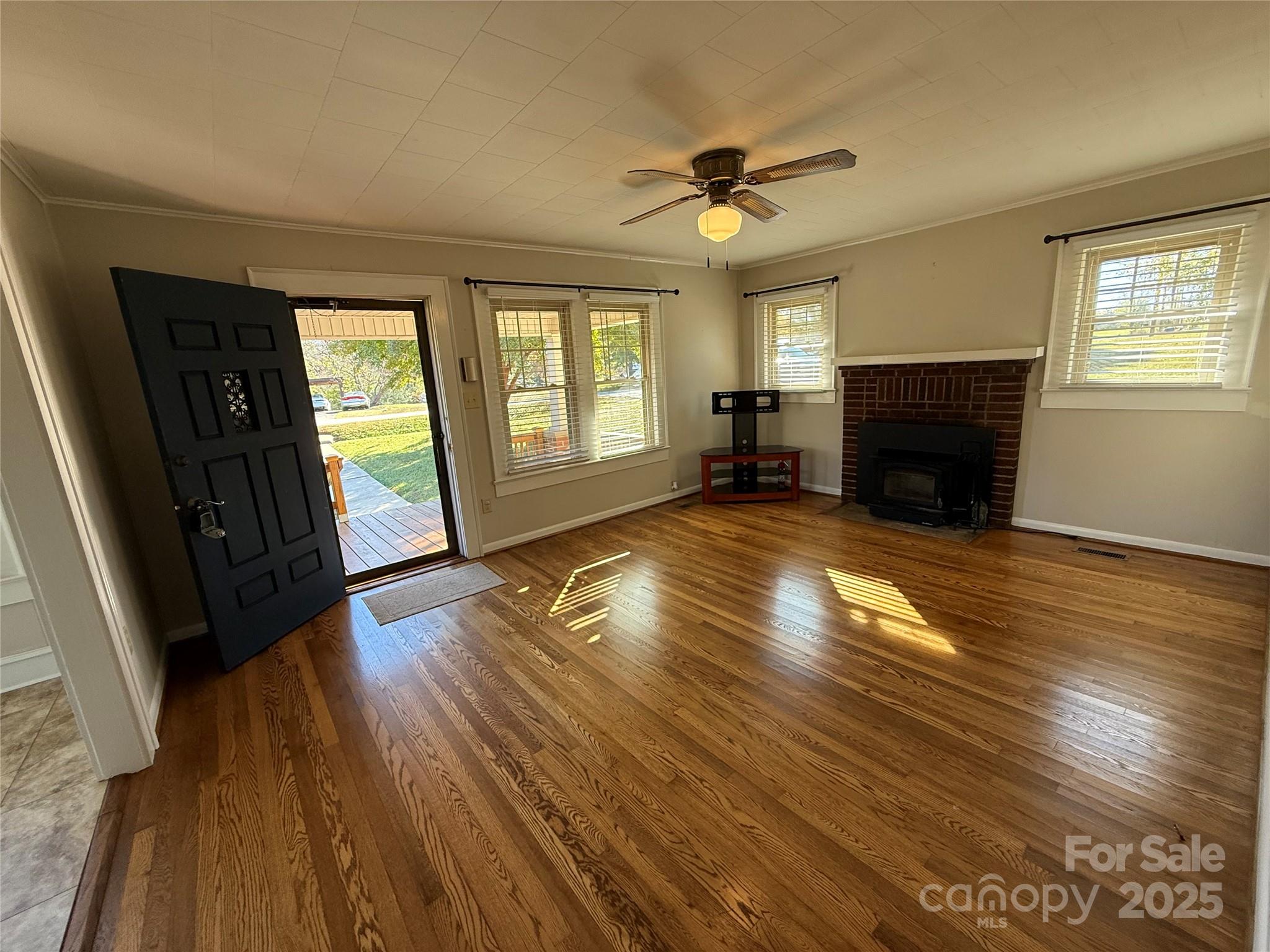 2550 Lail Road Glen Alpine, NC 28655 - Photo 9 of 35 a view of an empty room with wooden floor and a window