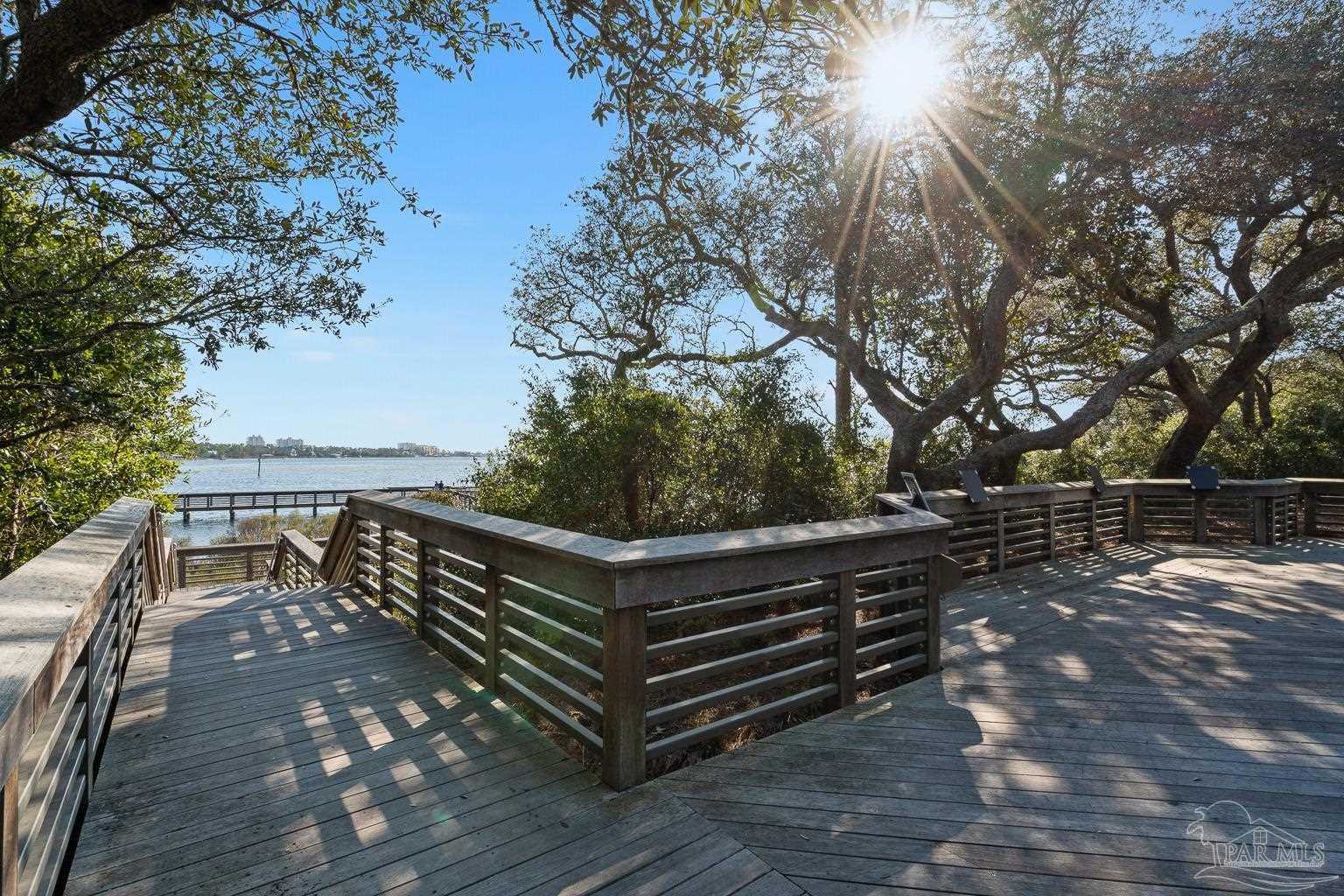 5314 North Shore Road Pensacola, FL 32507 - Photo 21 of 23 a wooden bench sitting in middle of a yard