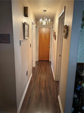 a view of a hallway and wooden floor